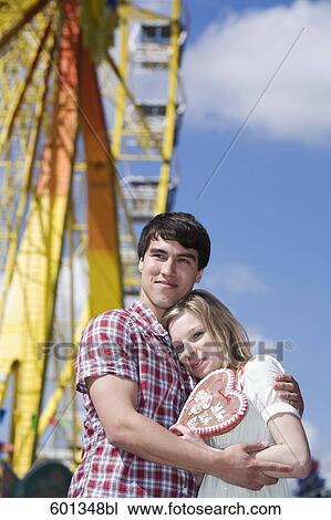 portrait of teenage couple with gingerbread heart at fun fair View Large Photo Image Stock Image - portrait of teenage couple with gingerbread heart at fun fair. Fotosearch