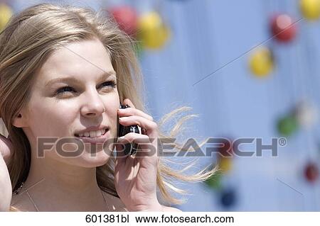 portrait of teenage girl talking on mobile phone at fun fair View Large Photo Image Stock Image - portrait of teenage girl talking on mobile phone at fun fair . Fotosearch