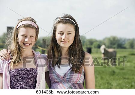 portrait of two girls on horse ranch View Large Photo Image Stock Image - portrait of two girls on horse ranch. Fotosearch
