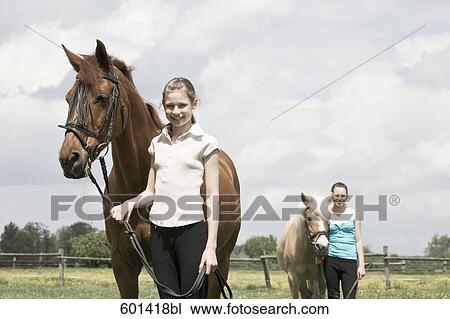 portrait of two girls with horses View Large Photo Image Stock Image - portrait of two girls with horses. Fotosearch