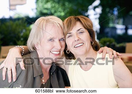 portrait of two senior woman sitting in embrace in cafe View Large Photo Image Stock Image - portrait of two senior woman sitting in embrace in cafe. Fotosearch