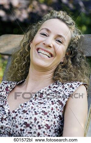 portrait of woman sitting in garden View Large Photo Image Stock Image - portrait of woman sitting in garden. Fotosearch