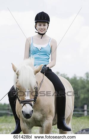 portrait of young girl doing horseback riding View Large Photo Image Stock Image - portrait of young girl doing horseback riding. Fotosearch