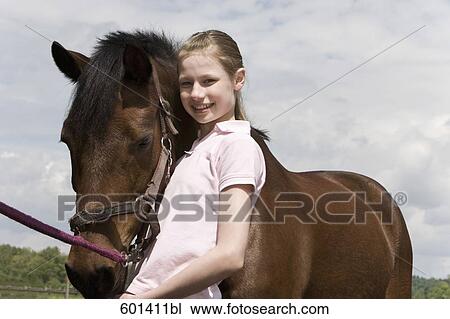 portrait of young girl with brown horse View Large Photo Image Stock Image - portrait of young girl with brown horse. Fotosearch
