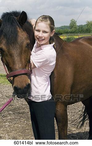 portrait of young girl with brown horse View Large Photo Image Stock Image - portrait of young girl with brown horse. Fotosearch