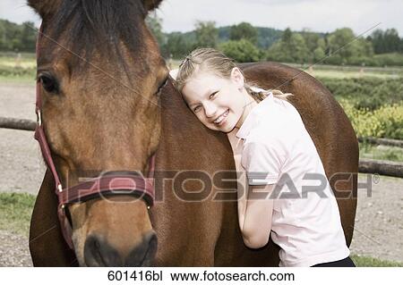 portrait of young girl with brown horse View Large Photo Image Stock Image - portrait of young girl with brown horse. Fotosearch