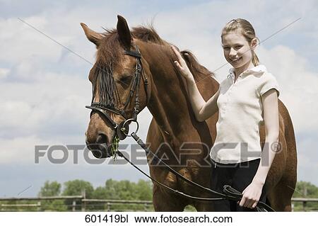 portrait of young girl with brown horse View Large Photo Image Stock Image - portrait of young girl with brown horse. Fotosearch