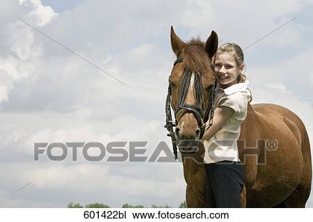 portrait of young girl with brown horse View Large Photo Image Stock Image - portrait of young girl with brown horse. Fotosearch