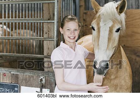 portrait of young girl with horse in stable View Large Photo Image Stock Image - portrait of young girl with horse in stable. Fotosearch