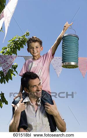 portrait of young on his father´s shoulders View Large Photo Image Stock Image - portrait of young on his father´s shoulders. Fotosearch