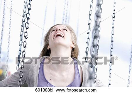 Stock Image - portrait of young woman sitting in chairoplane. Fotosearch