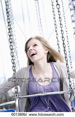Stock Image - portrait of young woman sitting in chairoplane. Fotosearch