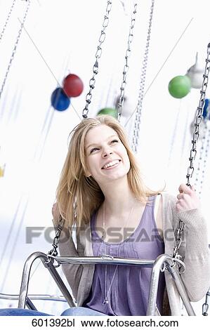 Stock Image - portrait of young woman sitting in chairoplane. Fotosearch