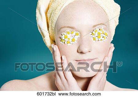 portrait of young woman with camomile on her eyes View Large Photo Image Stock Image - portrait of young woman with camomile on her eyes. Fotosearch