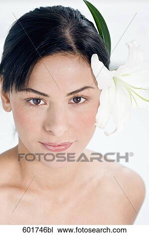 portrait of young woman with flower in her hair View Large Photo Image Stock Image - portrait of young woman with flower in her hair. Fotosearch