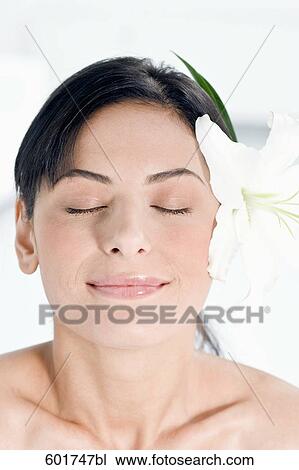 portrait of young woman with flower in her hair View Large Photo Image Stock Image - portrait of young woman with flower in her hair. Fotosearch