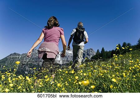 rear view of mature couple walking in the mountains View Large Photo Image Stock Image - rear view of mature couple walking in the mountains. Fotosearch