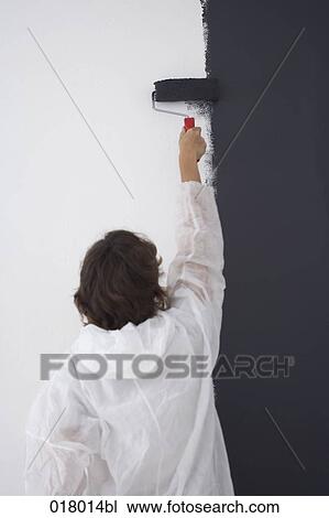 rear view of woman painting wall blue with paint roller View Large Photo Image Stock Image - rear view of woman painting wall blue with paint roller. Fotosearch