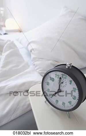 still life of alarm clock on sideboard with empty bed in background View Large Photo Image Stock Image - still life of alarm clock on sideboard with empty bed in background. Fotosearch