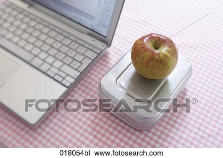 still life of apple on lunchbox beside computer View Large Photo Image Stock Image - still life of apple on lunchbox beside computer. Fotosearch