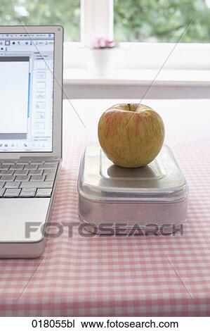still life of apple on lunchbox beside computer View Large Photo Image Stock Image - still life of apple on lunchbox beside computer. Fotosearch