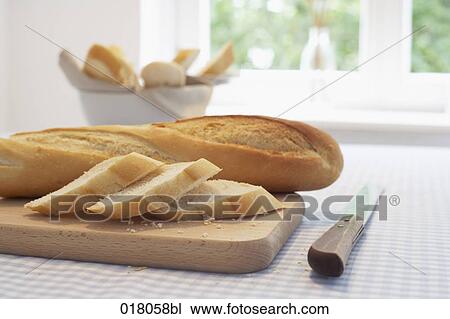 still life of baguette on cutting board View Large Photo Image Stock Image - still life of baguette on cutting board. Fotosearch