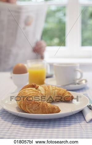 still life of breakfast table with man in the background reading newspaper View Large Photo Image Stock Image - still life of breakfast table with man in the background reading newspaper. Fotosearch