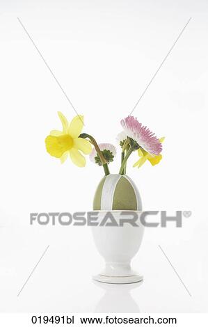Stock Image - still life of easter egg decorated with flowers in eggcup. Fotosearch