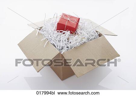 still life of red present coming out of cardboard box View Large Photo Image Stock Image - still life of red present coming out of cardboard box. Fotosearch