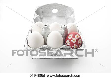 Stock Image - still life of six eggs in cardboard box one painted. Fotosearch
