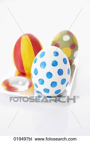 Stock Image - still life of thre painted easter eggs on plate. Fotosearch