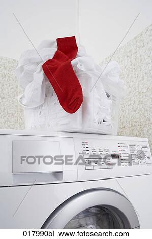 still life of white laundry with one red socke in basket standing washing machine View Large Photo Image Stock Image - still life of white laundry with one red socke in basket standing washing machine. Fotosearch