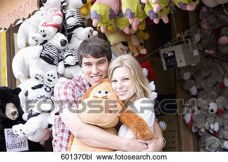 teenage couple at fun fair in close embrace View Large Photo Image Stock Image - teenage couple at fun fair in close embrace. Fotosearch