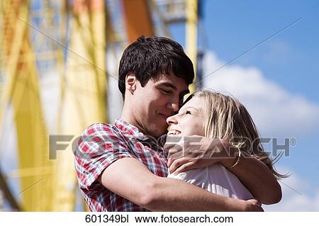teenage couple embracing at fun fair View Large Photo Image Stock Image - teenage couple embracing at fun fair. Fotosearch