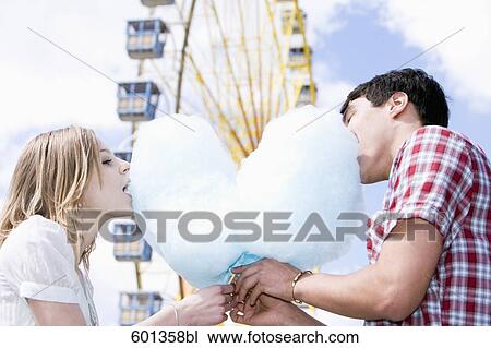 teenage couple sharing cotton candy at fun fair View Large Photo Image Stock Image - teenage couple sharing cotton candy at fun fair. Fotosearch