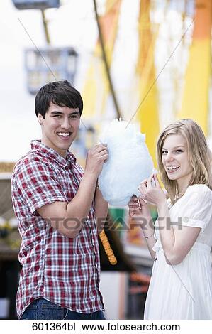 teenage couple sharing cotton candy at fun fair View Large Photo Image Stock Image - teenage couple sharing cotton candy at fun fair. Fotosearch