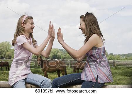 two friends playing together on horse ranch View Large Photo Image Stock Image - two friends playing together on horse ranch. Fotosearch