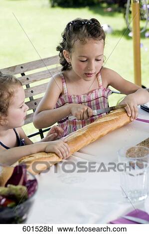 two little sisters sharing bread at table in garden View Large Photo Image Stock Image - two little sisters sharing bread at table in garden. Fotosearch