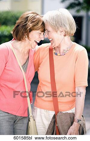 two senior female friends sharing a laugh View Large Photo Image Stock Image - two senior female friends sharing a laugh. Fotosearch
