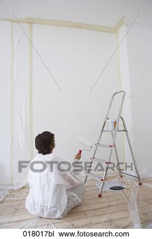 woman sitting on floor in empty flat holding paint roller View Large Photo Image Stock Image - woman sitting on floor in empty flat holding paint roller. Fotosearch