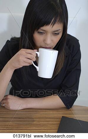 asian businesswoman drinking tea during meeting View Large Photo Image Stock Image - asian businesswoman drinking tea during meeting. Fotosearch