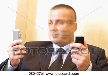 blurred headshot of mature businessman with two mobile phones View Large Photo Image Stock Image - blurred headshot of mature businessman with two mobile phones. Fotosearch
