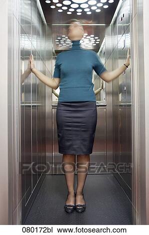 blurred portrait of businesswoman standing in elevator View Large Photo Image Stock Image - blurred portrait of businesswoman standing in elevator. Fotosearch