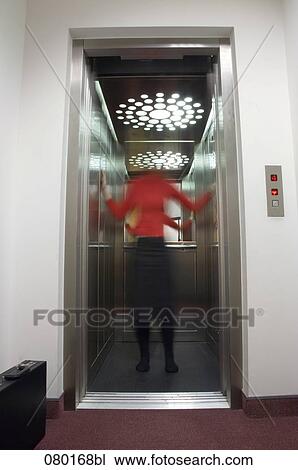 blurred portrait of woman standing in open elevator in office building View Large Photo Image Stock Image - blurred portrait of woman standing in open elevator in office building. Fotosearch