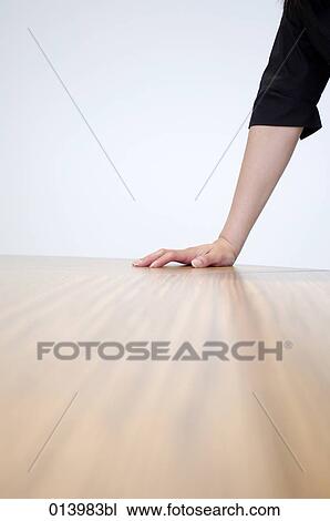 Stock Image - body detail of executive leaning on table. Fotosearch