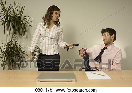 businessman cutting his own tie while female colleague is pulling it View Large Photo Image Stock Image - businessman cutting his own tie while female colleague is pulling it. Fotosearch