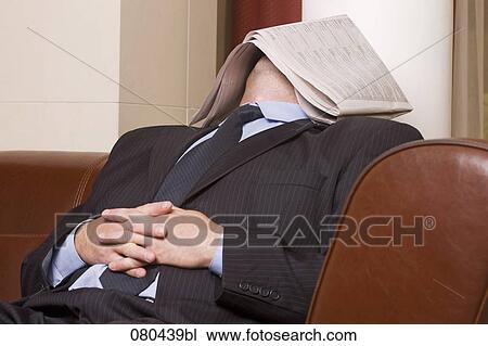 businessman dozing in hotel lobby with newspaper covering his face View Large Photo Image Stock Image - businessman dozing in hotel lobby with newspaper covering his face. Fotosearch