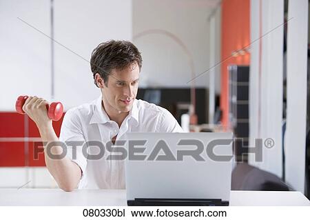 businessman exercising with dumb bell while sitting at laptop computer View Large Photo Image Stock Image - businessman exercising with dumb bell while sitting at laptop computer. Fotosearch
