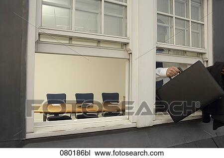 businessman leaving office building through window View Large Photo Image Stock Image - businessman leaving office building through window. Fotosearch