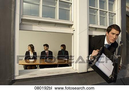 businessman leaving office building through window with briefcase full of confidential documents View Large Photo Image Stock Image - businessman leaving office building through window with briefcase full of confidential documents. Fotosearch